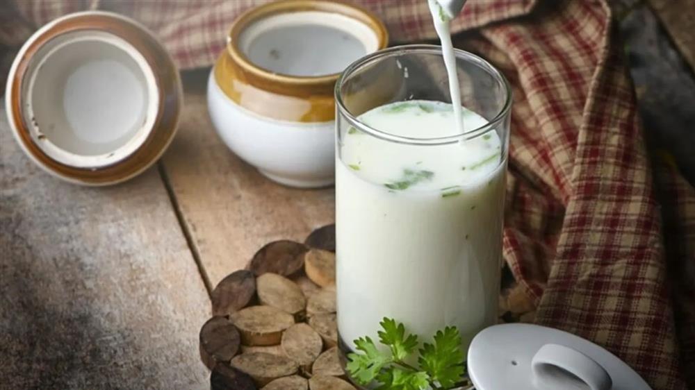 A glass of buttermilk being filled